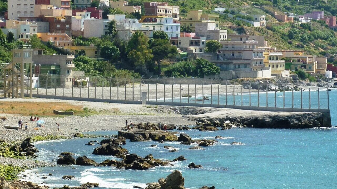 Grenzzaun zwischen Marokko und der spanischen Enklave Ceuta am Strand