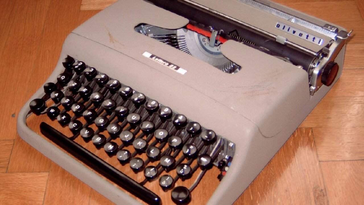 Alte Olivetti-Reiseschreibmaschine auf Holzboden (Symbolbild)
