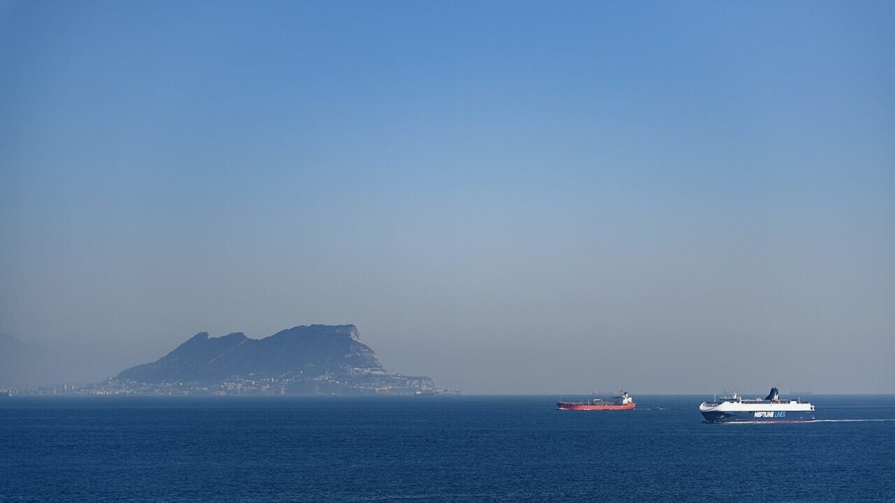 Frachtschiffe passieren die Straße von Gibraltar vor dem Felsen von Gibraltar